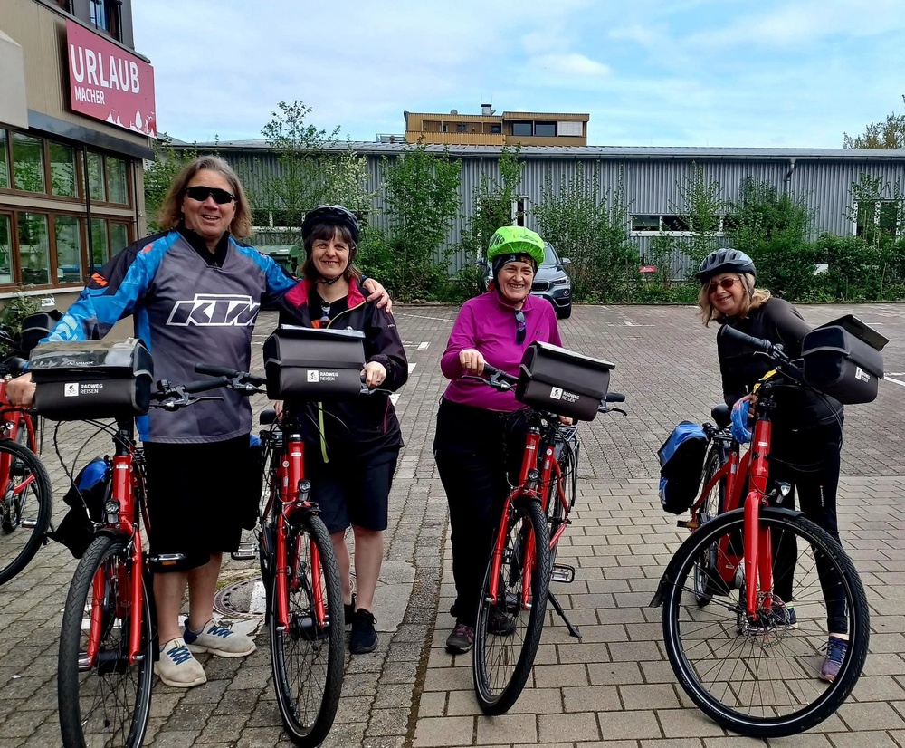Ms Warren on a bike with Lisa, her brother Gary and sister-in-law Teresa (PA)