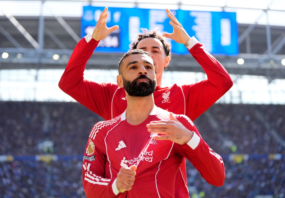 Liverpool’s Curtis Jones mimes crowning Mohamed Salah as he celebrates (PA)