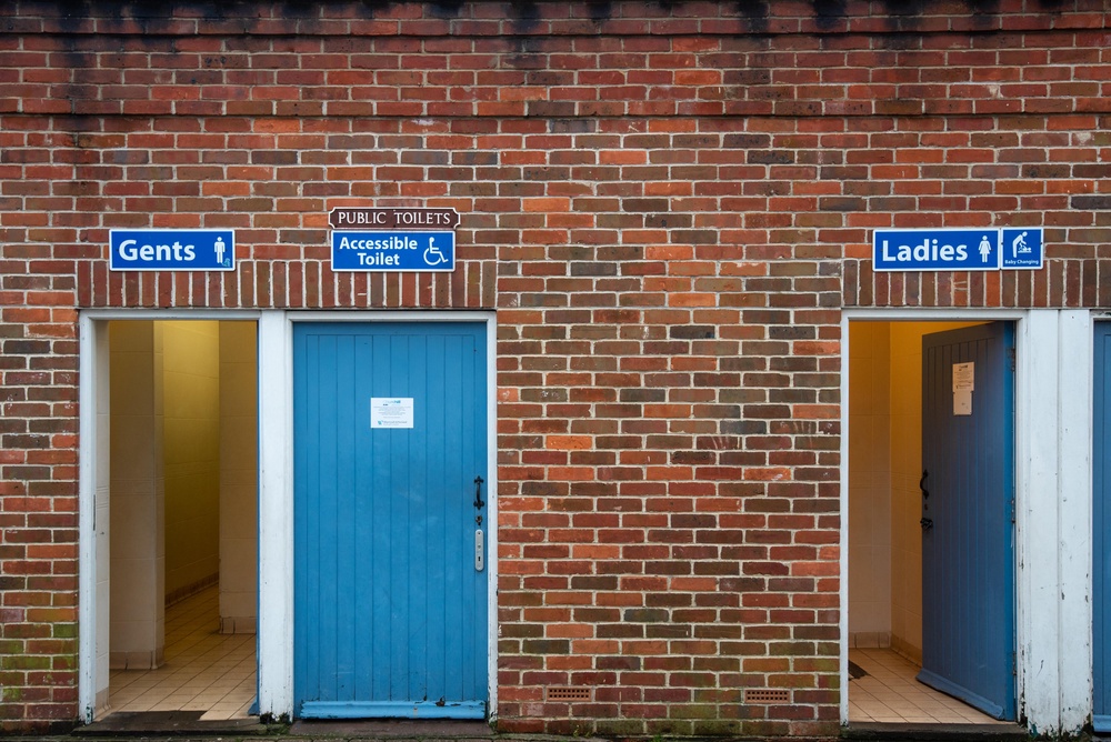 MRJEG7 Public Toilets, Ladies, Gents and Accessible toilets with blue wooden doors in an old red brick building.