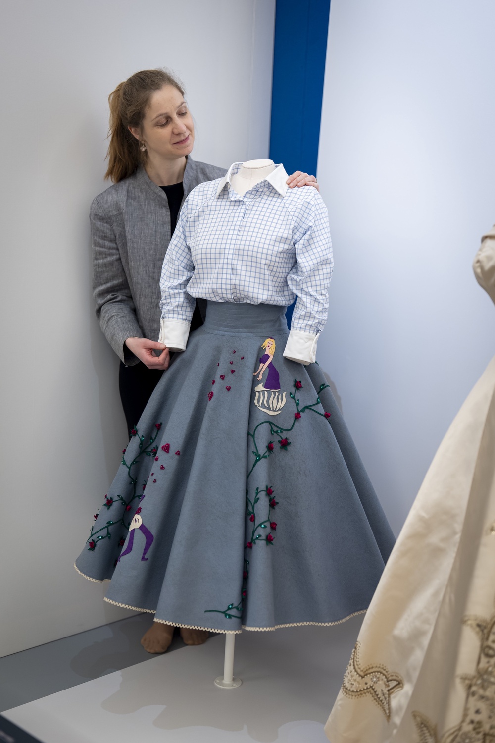 A textile conservator adjusts the ‘poodle skirt’ (Aaron Chown/PA) (PA Wire)