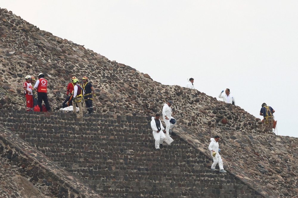 Jasso was the only gunman and later died by a self-inflicted gunshot wound, authorities said. Pictures showed forensic officers removing his body and that of the Canadian tourist from the site (Reuters)