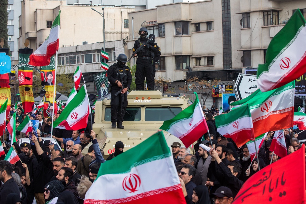 Members of security forces watch over the crowd during a funeral procession held for IRGC Navy Chief Alireza Tangsiri. The IRGC could be one of the organisations listed after the State Threats bill passes. (Getty)