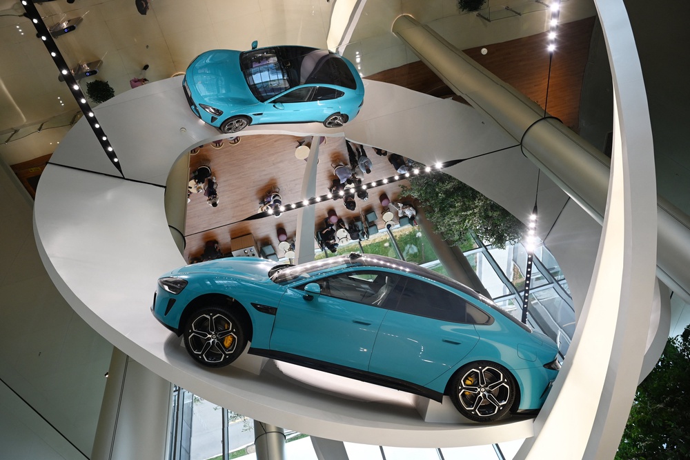 A Xiaomi SU7 Max car is displayed at the entrance to the Xiaomi EV Factory (AFP/Getty)