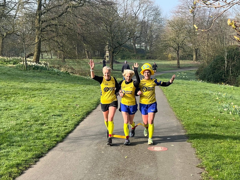 (l to r) Dr Sarah Holmes, Sam Cheverton and Helen Caldwell will run the TCS London Marathon on Sunday tied at the ankle (Marie Curie/PA) (PA Media)