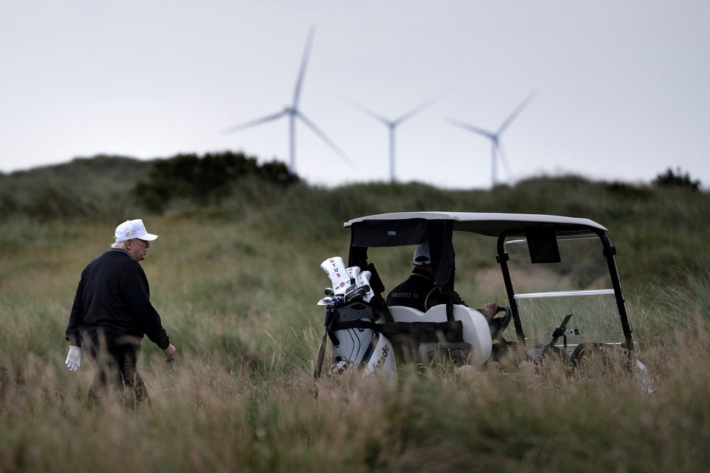 Donald Trump, pictured at his golf course in Aberdeenshire, Scotland, is a notorious critic of wind farms (AFP/Getty)