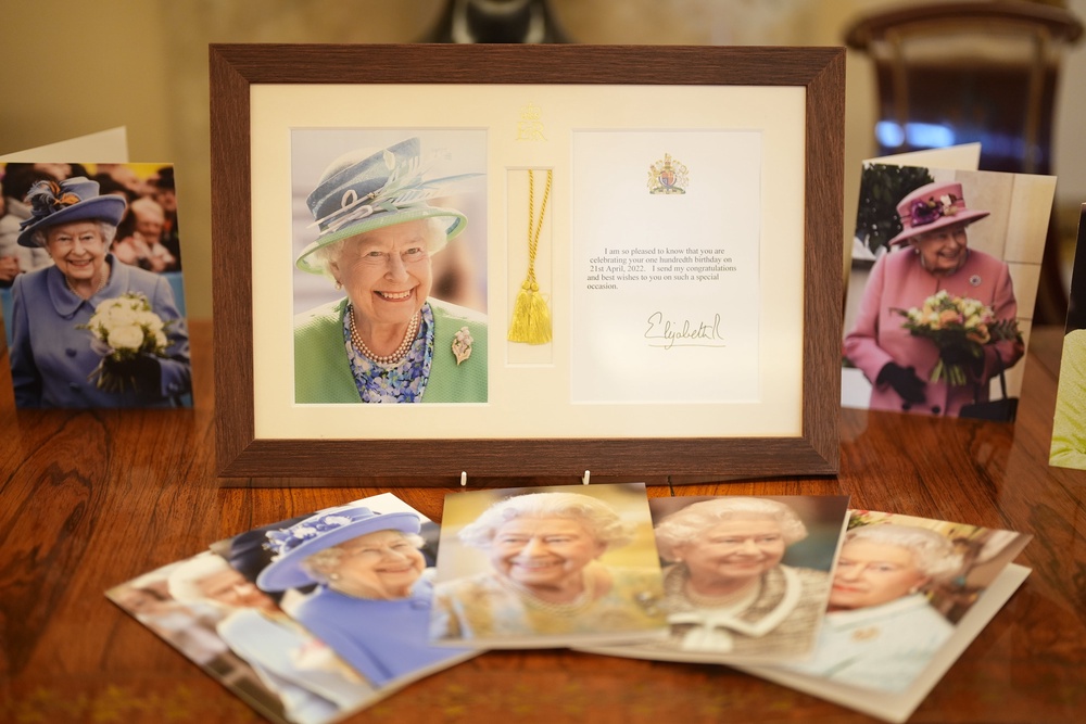 Photographs of Queen Elizabeth II on display at a reception at Buckingham Palace (Jordan Pettitt/PA) (PA Wire)