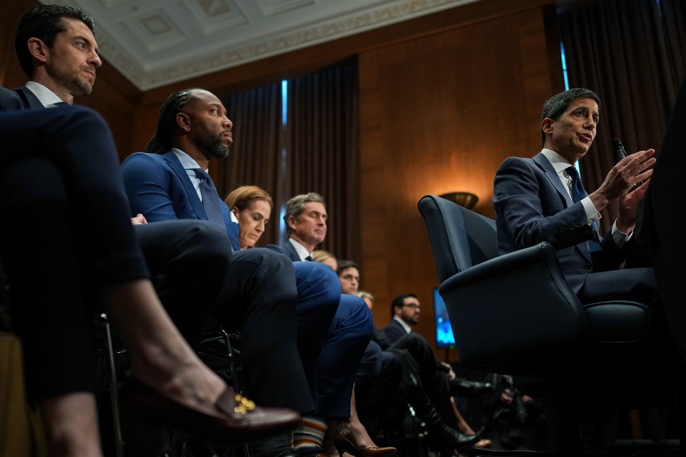 Kevin Warsh. President Donald Trump's nominee for Chair of the Federal Reserve, testifies as former NFL player Larry Fitzgerald Jr. (left) looks on during his Senate Committee on Banking, Housing, and Urban Affairs confirmation hearing in the Dirksen Senate Office Building on April 21 (Getty)