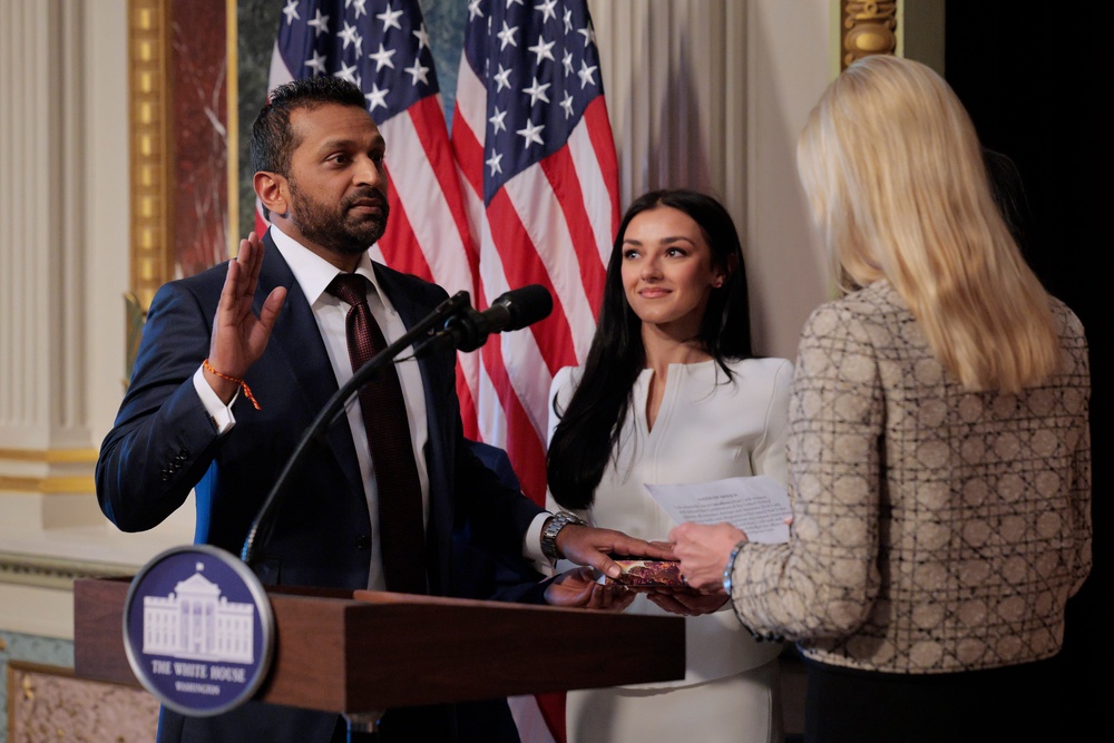 The real-life Patel at his swearing-in alongside his girlfriend, country music singer Alexis Wilkins. His visits with her have become fodder for attacks by his critics (Getty)