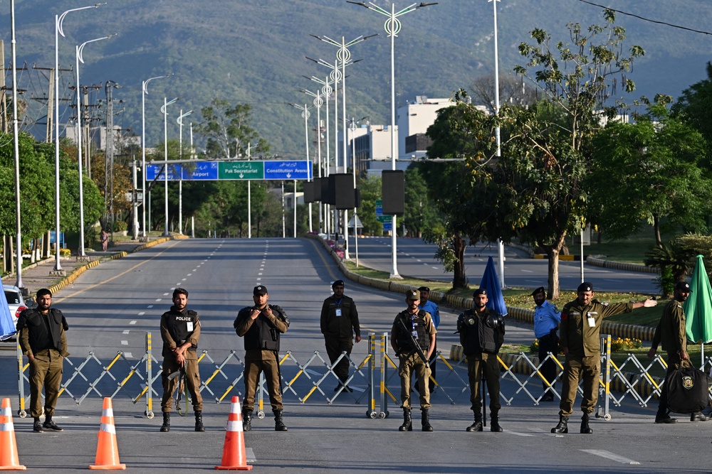 Police officers stand guard at a closed road leading to the Serena Hotel at the Red Zone area in Islamabad on April 22, 2026 (AFP/Getty)