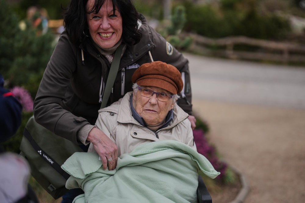 Ingrid Barkow, left, is wrapped in a blanket by her daughter Manuela Grudda, during a guided tour for people with dementia at Berlin Zoo (AP)