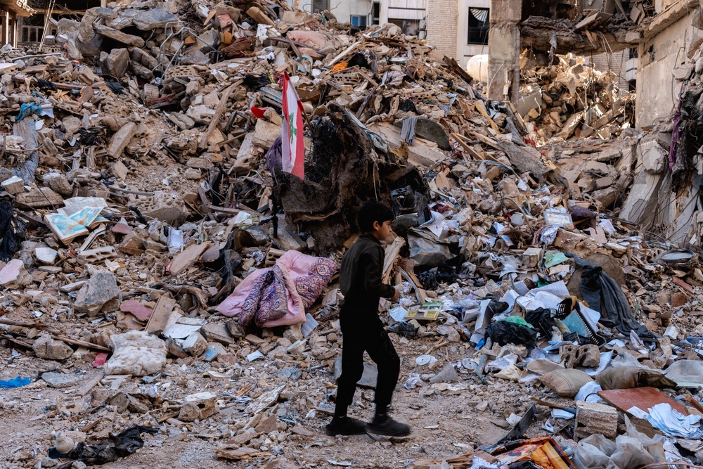 A boy stands near a destroyed building in the residential neighbourhood of Ain el-Mreisseh near the seafront in Beirut, Lebanon, on 11 April (AFP/Getty)