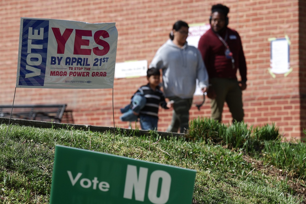 Voters depart after casting their ballots at a polling location at the Westover Library on April 21 (Getty)