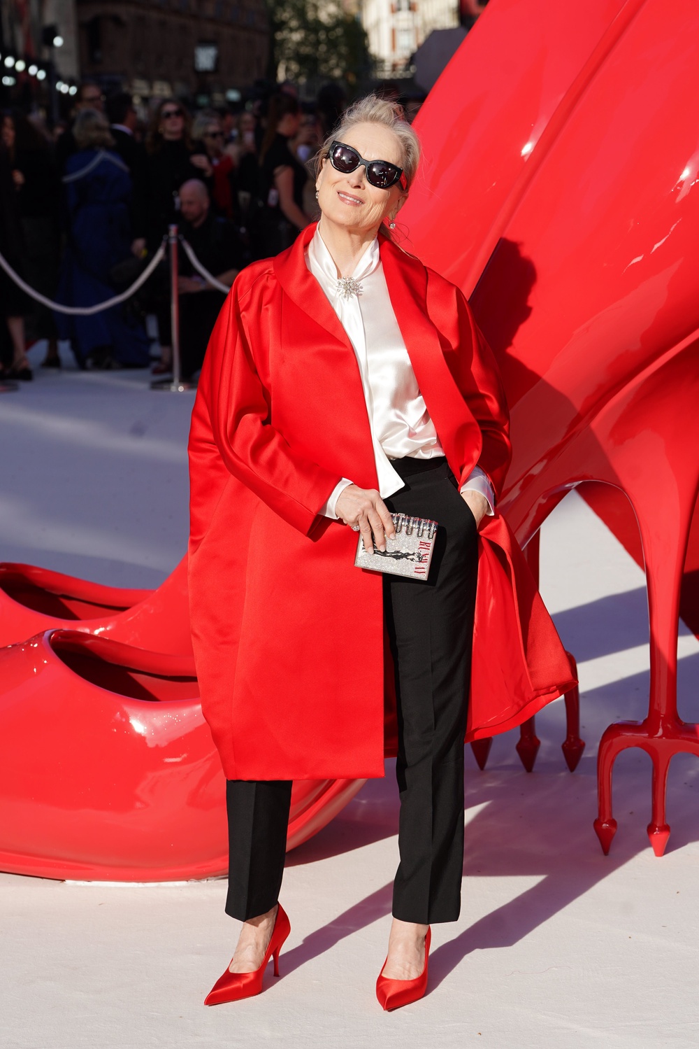 Meryl Streep in a red Prada coat (Ian West/PA)