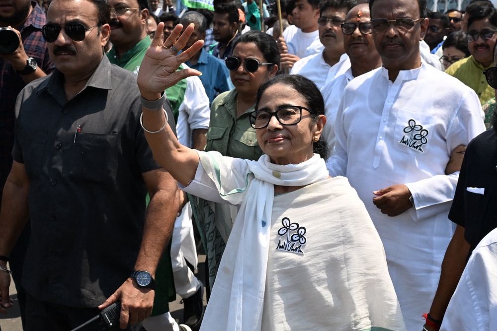 West Bengal chief minister Mamata Banerjee greets supporters as she arrives to file her nomination papers earlier this month (AFP/Getty)