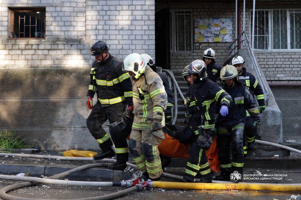 Rescuers carry a body of the person found under debris of a building which was hit during Russian drone strike, amid Russia's attack on Ukraine, in Dnipro (Reuters)