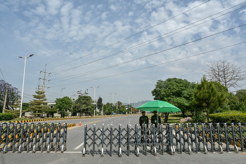 Security personnel stand guard at a closed road leading to the Serena Hotel in the Red Zone area of Islamabad on 23 April 2026. - Pakistan's capital was still locked in gear on 22 April to host high-stakes US-Iran talks that were pushed back at the last minute overnight, but many residents began to tire of the heavy personal and economic toll of tight security restrictions (AFP/Getty)