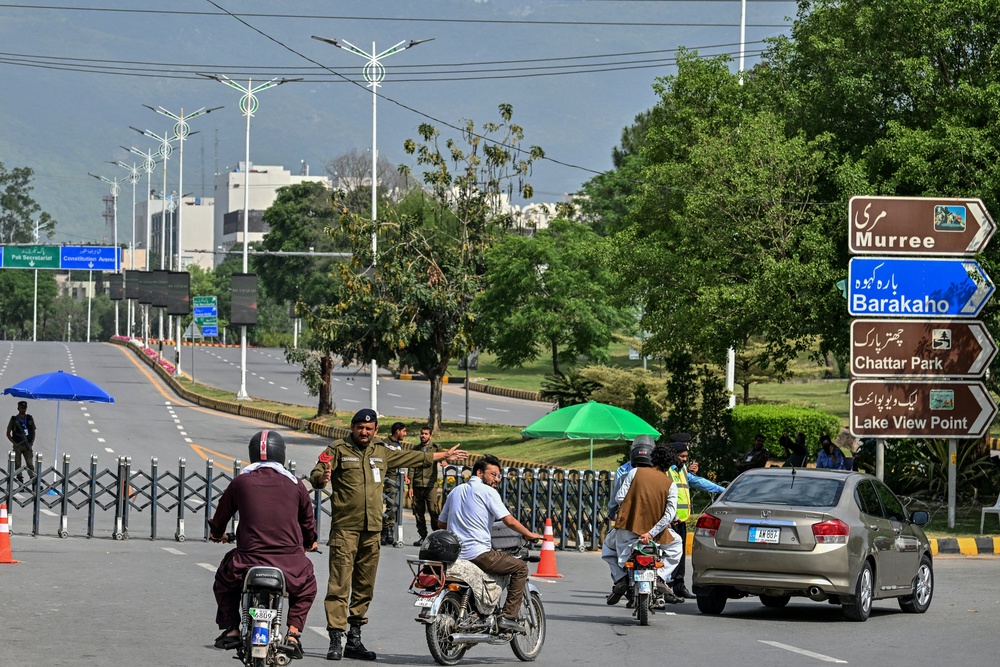 A security personnel manages traffic at a closed road leading to the Serena Hotel in the Red Zone area of Islamabad on 23 April 2026 (AFP/Getty)