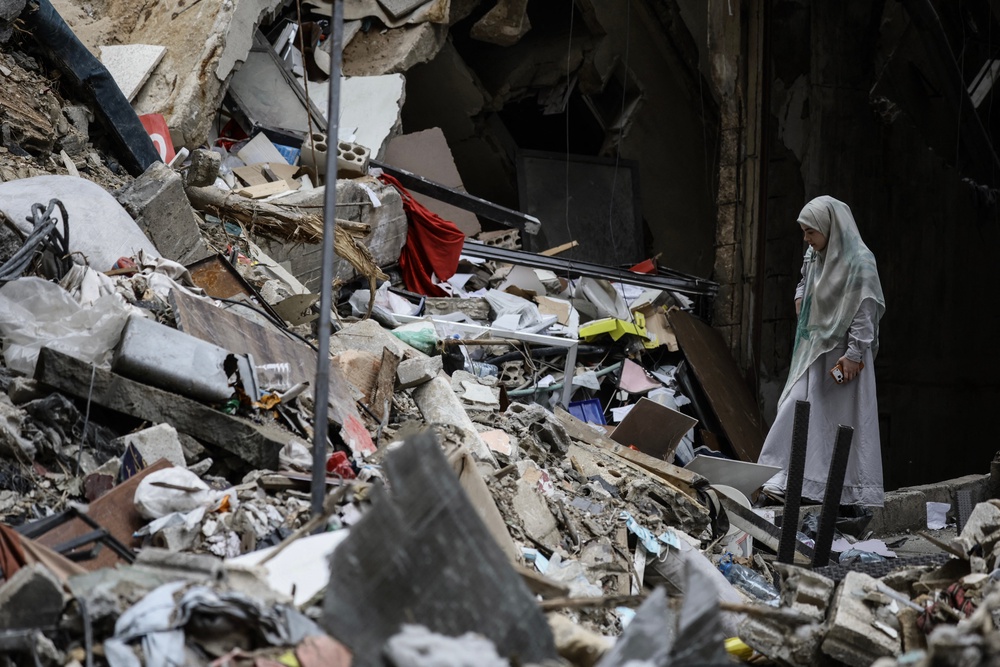A woman stands amid the debris of a destroyed building in the Haret Hreik area of Beirut's southern suburbs during a media tour organised by Iran-backed militant group Hezbollah on April 20 (AFP/Getty)