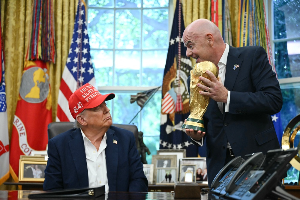 FIFA president Gianni Infantino hands the World Cup Trophy to Donald Trump on August 22, 2025 (Photo by ANDREW CABALLERO-REYNOLDS / AFP) (AFP/Getty)