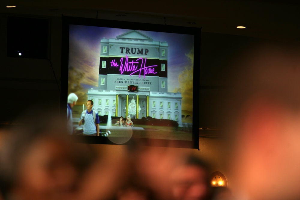 A projected image is shown on a large screen during Barack Obama's speech at the 2011 dinner which Obama used to show what a ‘Trump’ White House might look like (Getty Images)