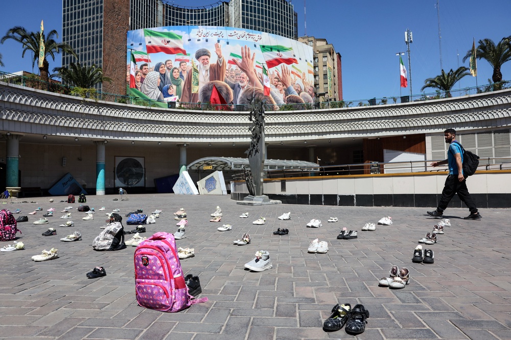 Symbolic belongings laid on the ground at Valiasr Square in Tehran on April 24, 2026, in tribute to the schoolgirls in Minab killed in an airstrike (AFP/Getty)