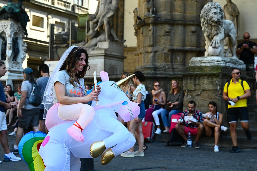A woman rides an inflatable unicorn during a bachelorette party at Florence's Piazza della Signoria. Social media is awash with photos of themed bachelorette parties (AFP via Getty Images)