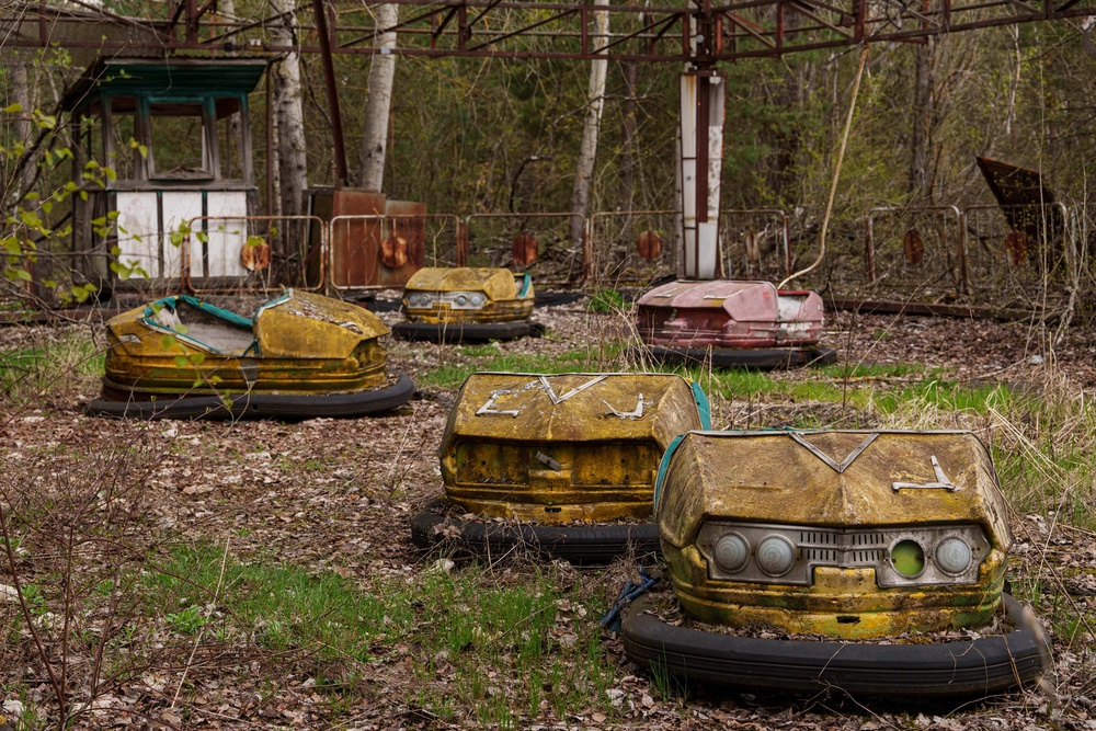 Bumper cars sit idle at an overgrown amusement park in Pripyat, Ukraine, a town left abandoned following the nearby 1986 Chernobyl nuclear disaster (AP)