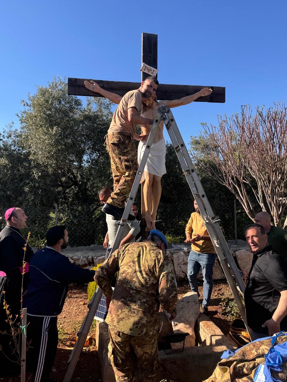 An Italian peacekeeper sets up a crucifix that was sent by Italy to replace one that was defaced last week by an Israeli soldier in the Christian village of Debel, south Lebanon, Wednesday, April 22, 2026. (Hossam Naddaf via AP) (Local Library)
