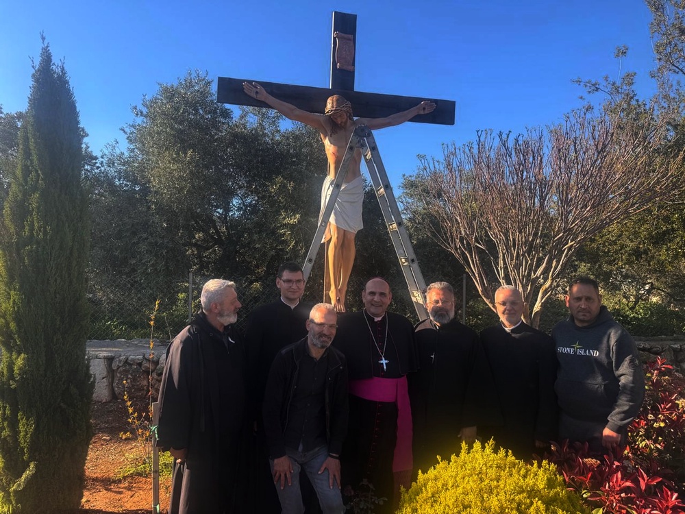 The Apostolic Nuncio to Lebanon Monsignor Paolo Borgia, center, poses with residents next to a crucifix sent by Italy to replace one that was defaced last week by an Israeli soldier in the Christian village of Debel, south Lebanon, Wednesday, April 22, 2026. (Houssam Naddaf via AP) (Local Library)