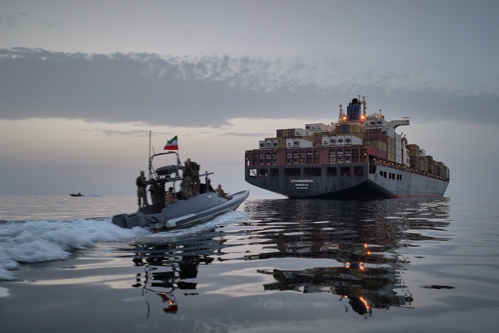 A Revolutionary Guard Navy (IRGC) speedboat approaches the cargo ship Epaminondas during what state media described as the seizure of one of two vessels accused of violations in the Strait of Hormuz (AP)