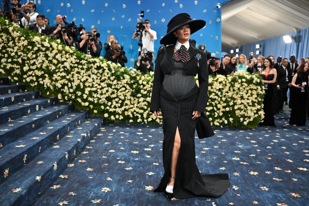 Rihanna on the Met Gala carpet in 2025. The midnight blue background and yellow daffodils were hand-painted on the 2025 Met Gala red carpet after it was constructed over 90 days in India (AFP via Getty Images)