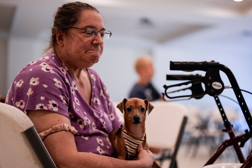 Jennifer Murphy and her dog Chip sit inside the Southside Baptist church (AP)