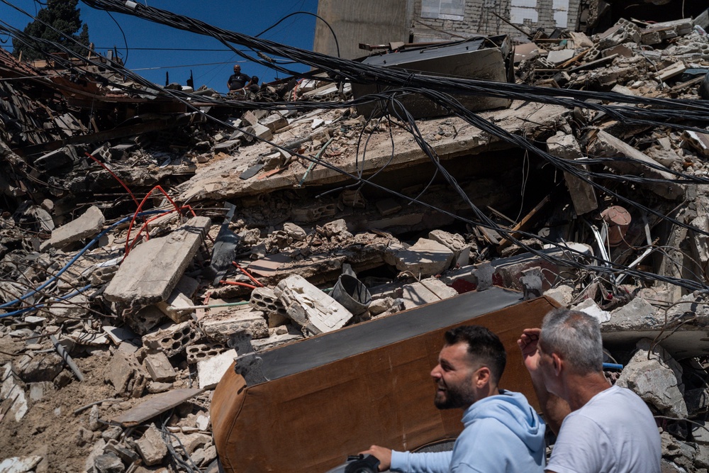 Neighbours on a motorbike checking the aftermath of an israeli airstrike on April 23, 2026 in Tyre, Lebanon (Getty Images)