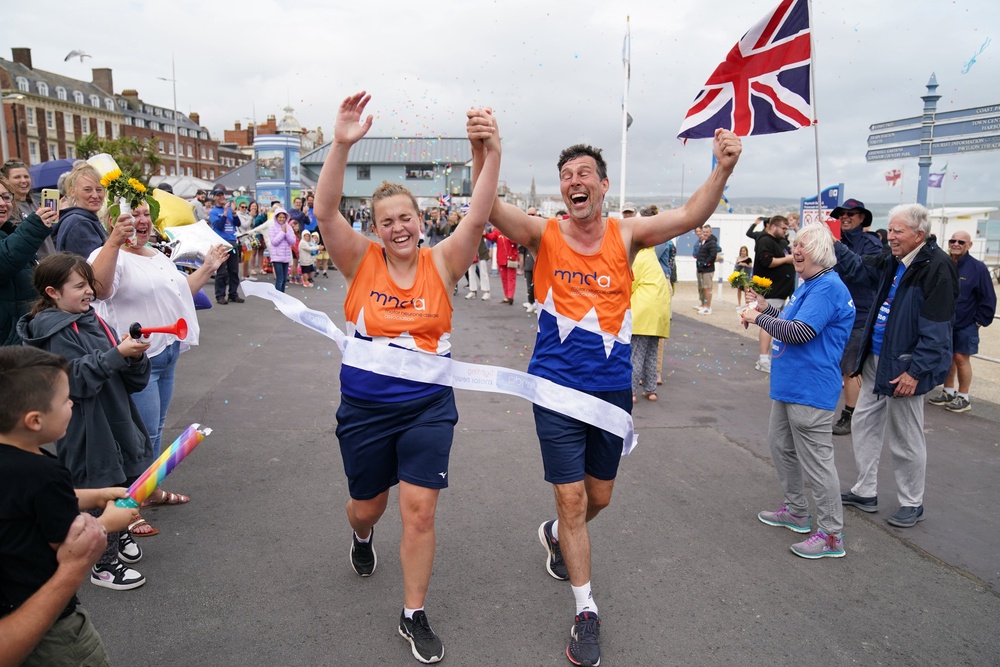 Charlotte Nichols and Stuart Bates finishing their marathon along the seafront in Weymouth in 2021 (Andrew Matthews/PA) (PA Archive)