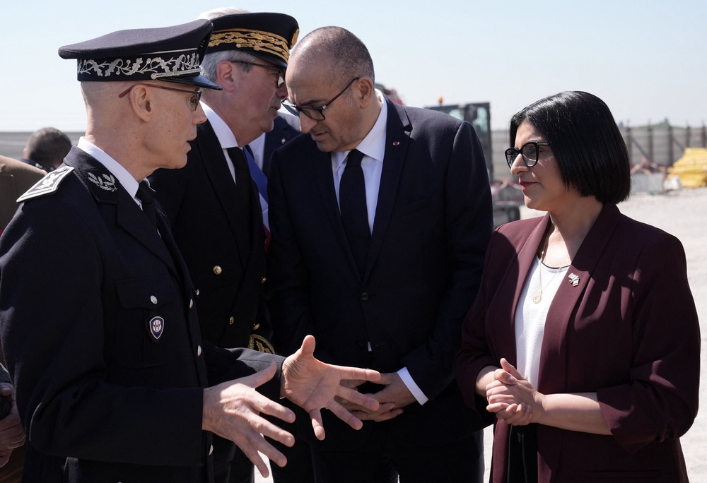 Mahmood and France's interior minister Laurent Nunez and French police officers at the construction site of a new illegal migrant detention centre in Dunkirk (AFP/Getty)