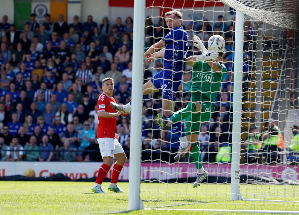 Dan Moss clattered into York goalkeeper Harrison Male to illegally force the ball over the line (PA)