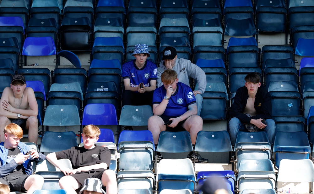 Rochdale fans sit dejected in the stands after missing out on the title (PA)