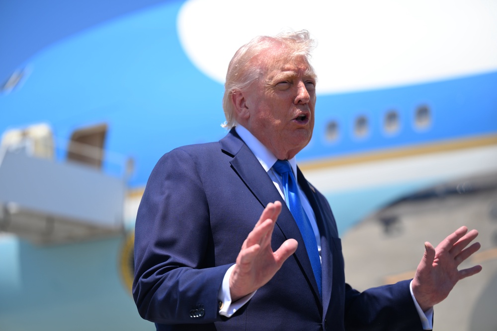 Trump speaks to the press before boarding Air Force One at the Palm Beach International Airport (Getty)
