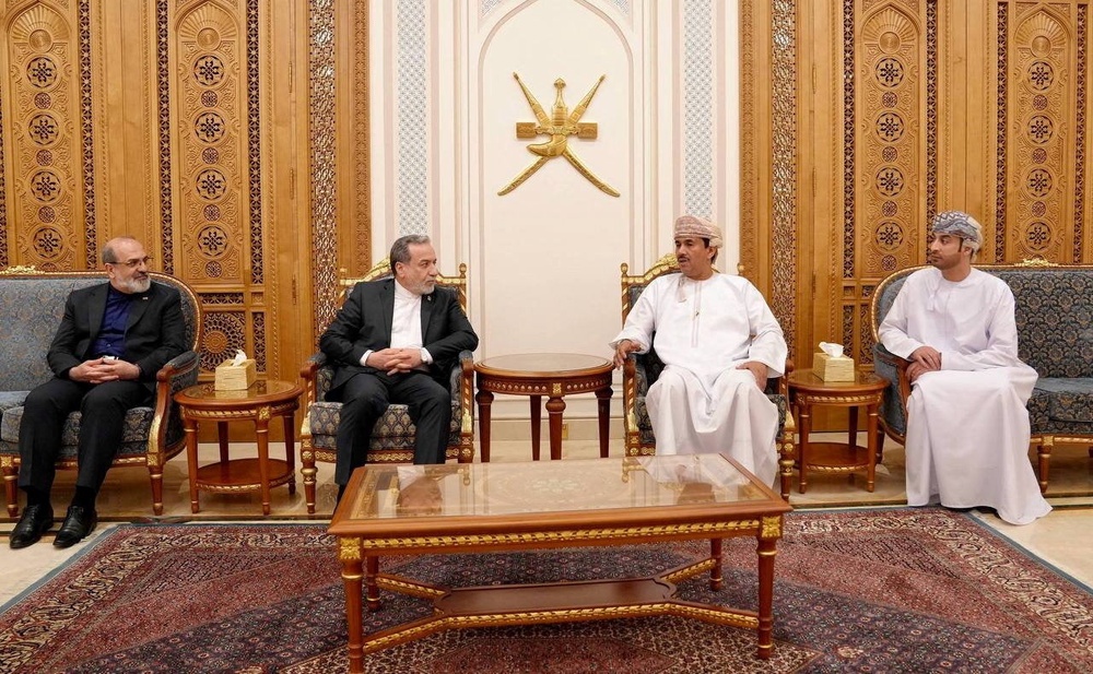 Iranian Foreign Minister Abbas Araqchi sits down with Senior Omani Diplomat, Najib Bin Yahya Al Balushi and other officials on the day of a meeting, in a location given as in Muscat, Oman (Reuters)