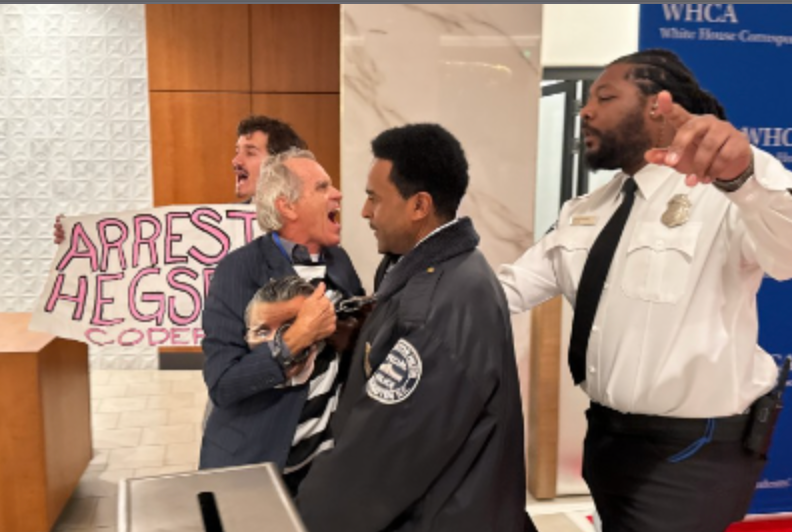 The pair were quickly escorted away from the red carpet, photos show (Getty)