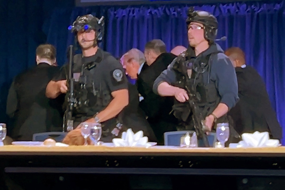 Shortly after the event started, shots rang out and President Donald Trump was rushed from the stage. First lady Melania Trump and other Cabinet members were present for the event (Reuters)