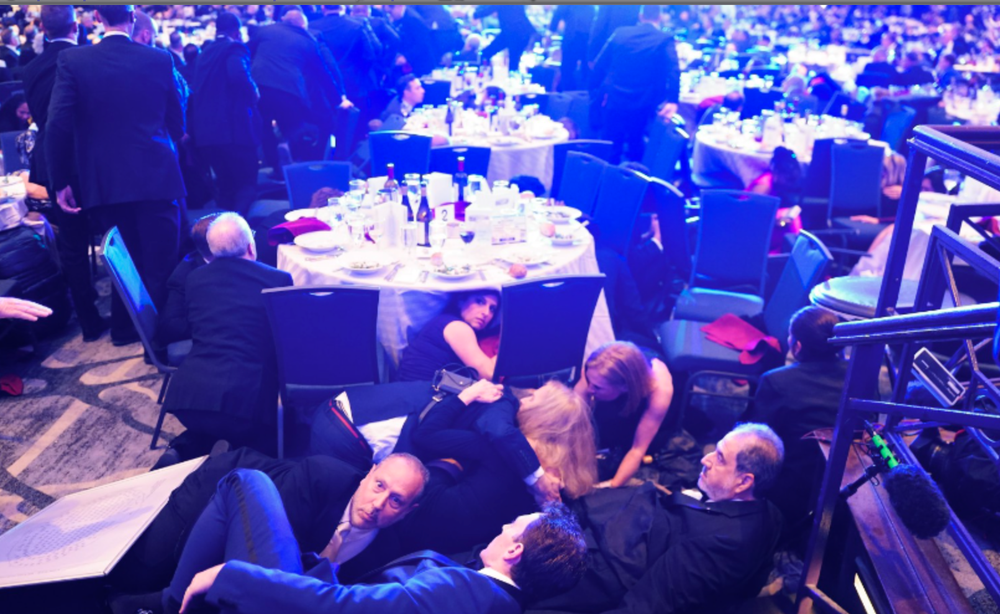 Attendees seen taking cover on the ground (Getty)