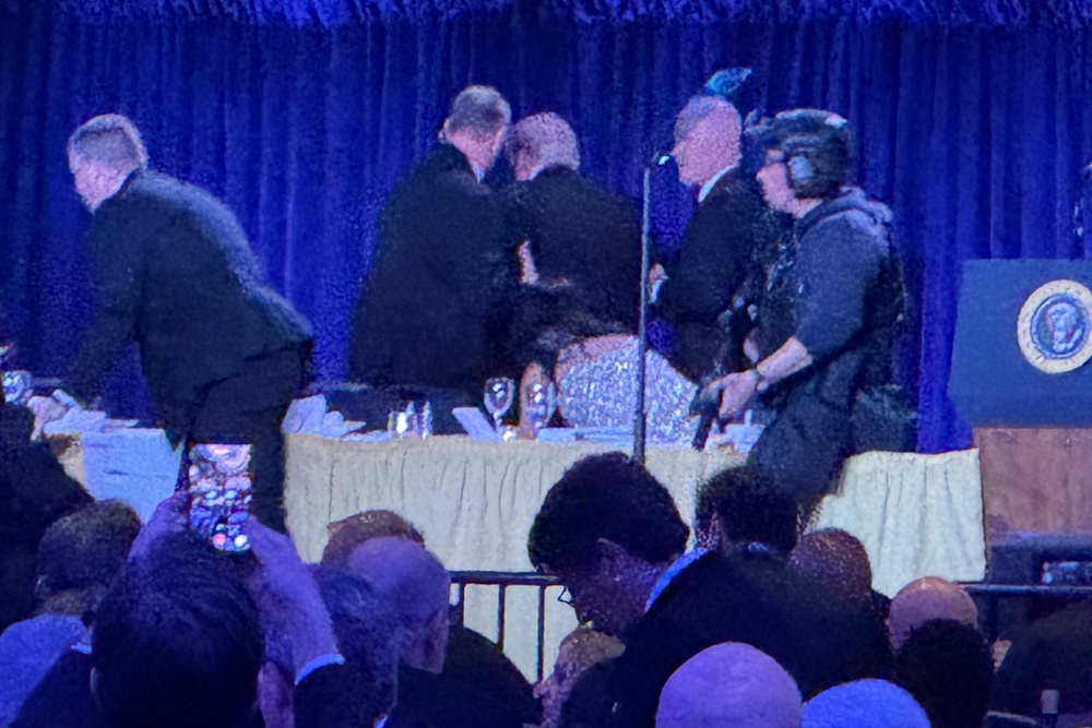 US secret service agents surround President Donald Trump as he is taken from the stage (Mark Schiefelbein/AP) (AP)