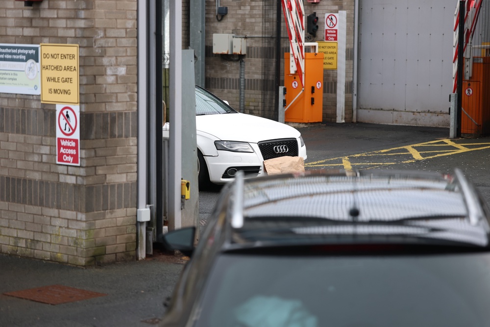 A white Audi car parked inside the police station in Lurgan, Co Armagh after a delivery driver was threatened at gunpoint in March (PA) (PA Wire)