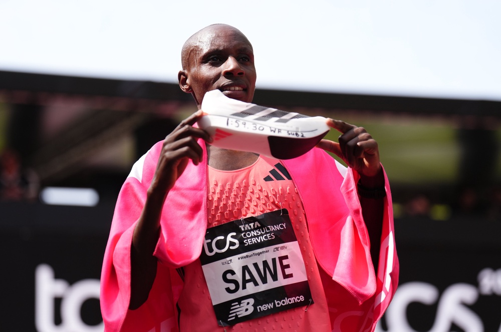Sabastian Sawe displays his running shoe marked with his world record time after winning the London Marathon (John Walton/PA) (PA Wire)