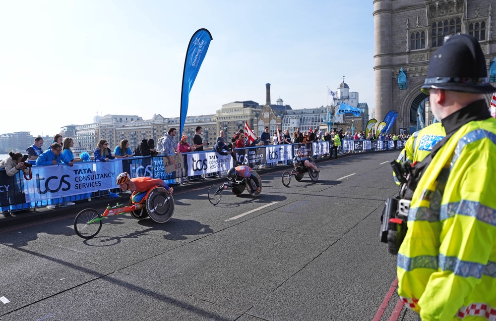Police watch the wheelchair racers on Sunday morning (Jonathan Brady/PA) (PA Wire)