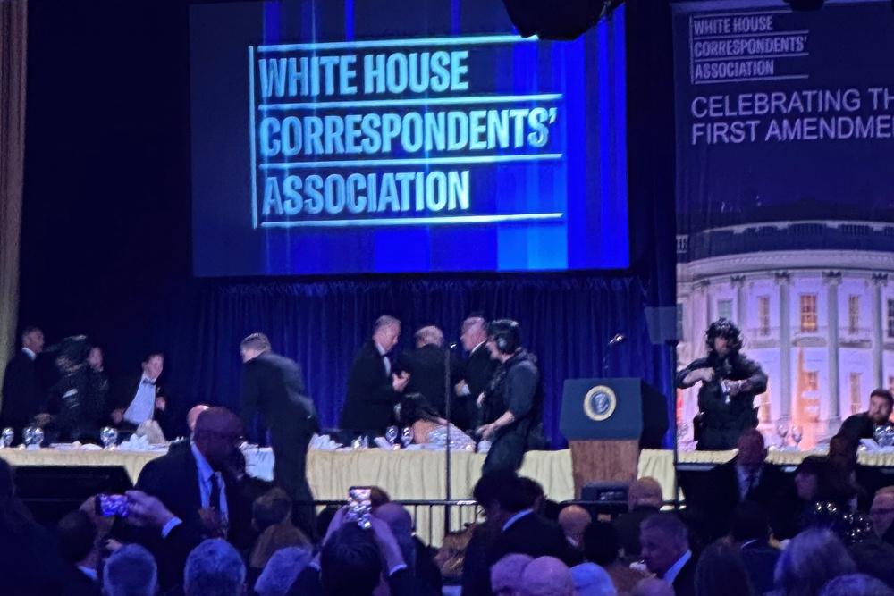 Secret service agents surround President Donald Trump as he is taken from the stage (Alex Brandon/AP) (AP)