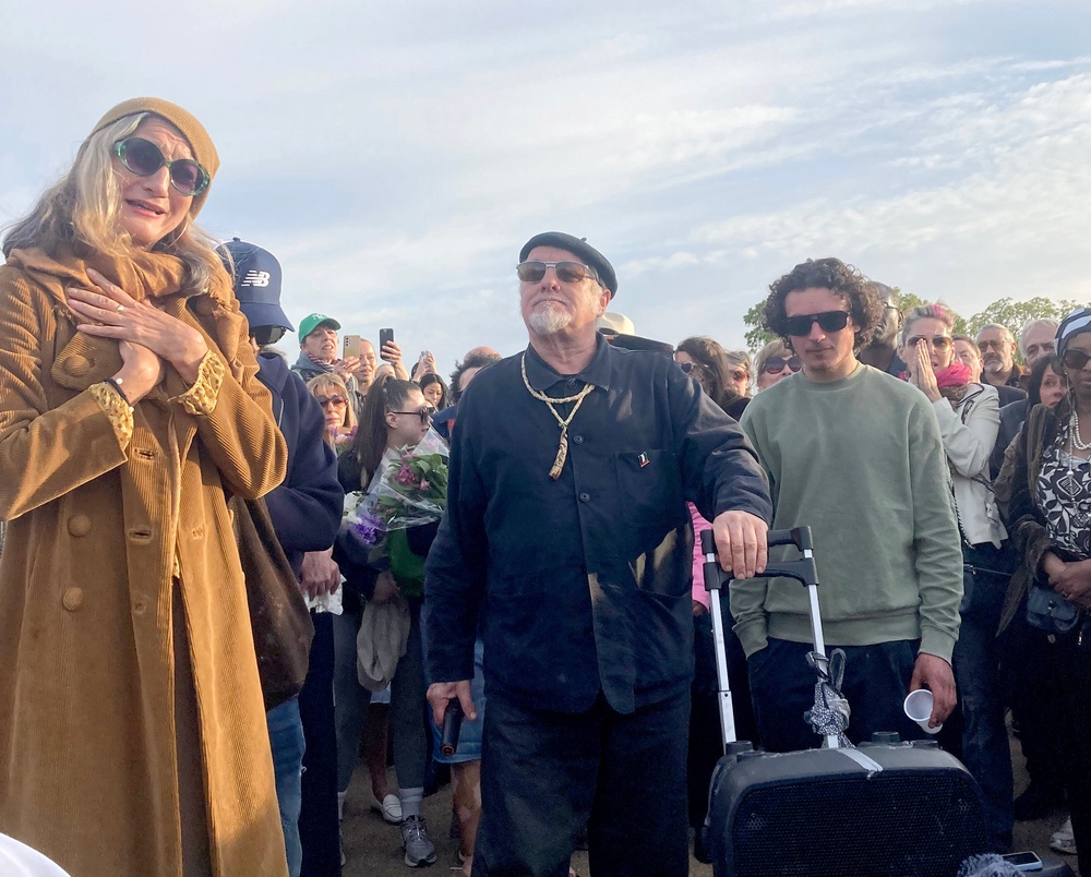 Finbar Sullivan’s parents, Leah Seresin (left) and Chris Sullivan (centre), join a vigil on Primrose Hill, north London, in memory of the 21-year-old filmmaking student (PA)