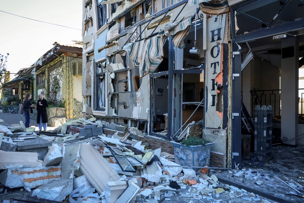Residents stand at the site of a hotel hit by a Russian drone strike in Odesa, Ukraine April 27 (Reuters)