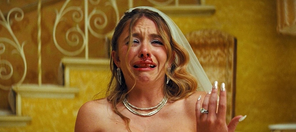 Sydney Sweeney's character Cassie cried in her wedding gown as her new husband Nate, played by Jacob Elordi, was beat by his debt collectors on their wedding night (HBO Max)